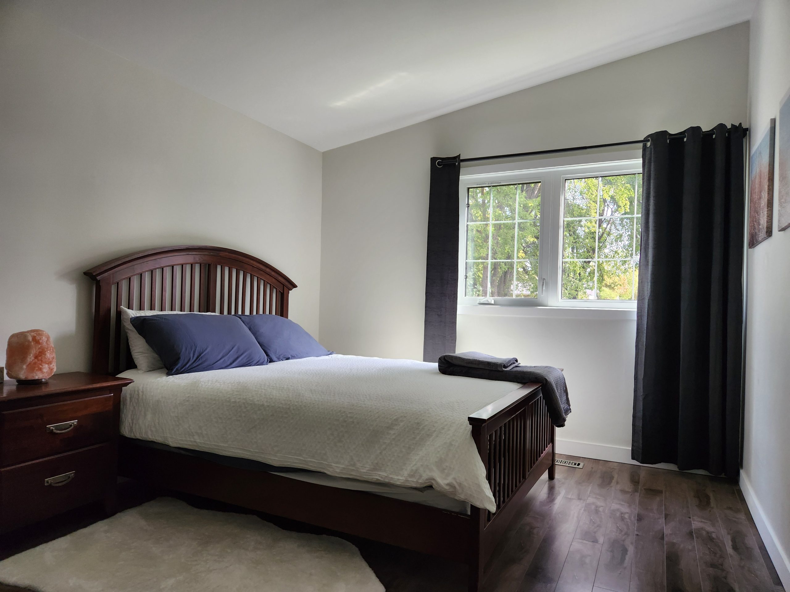 Outdoor patio with firepit and umbrella seating at Gimli guest suite